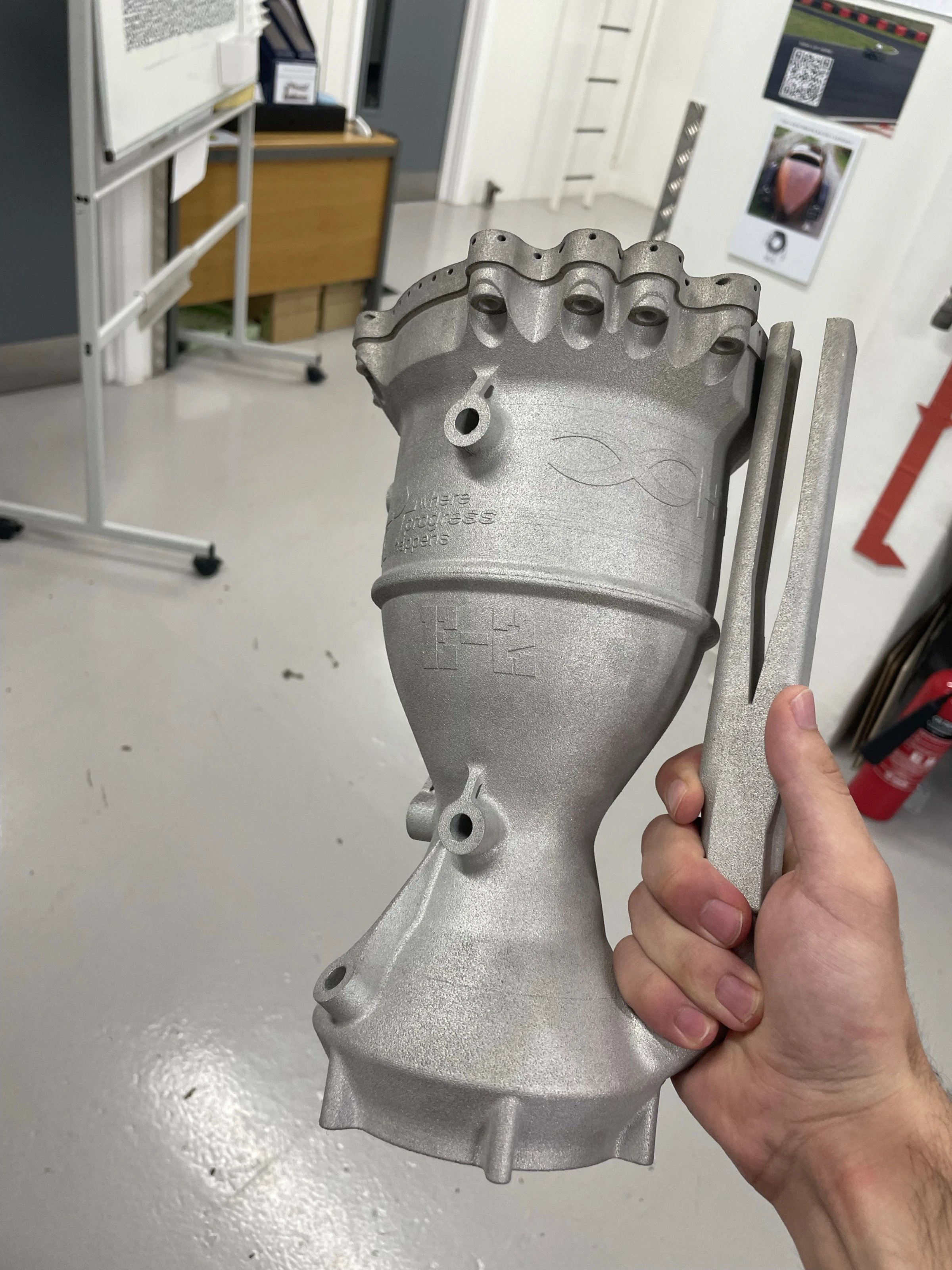 The finished flight-weight aluminium chamber held in one hand