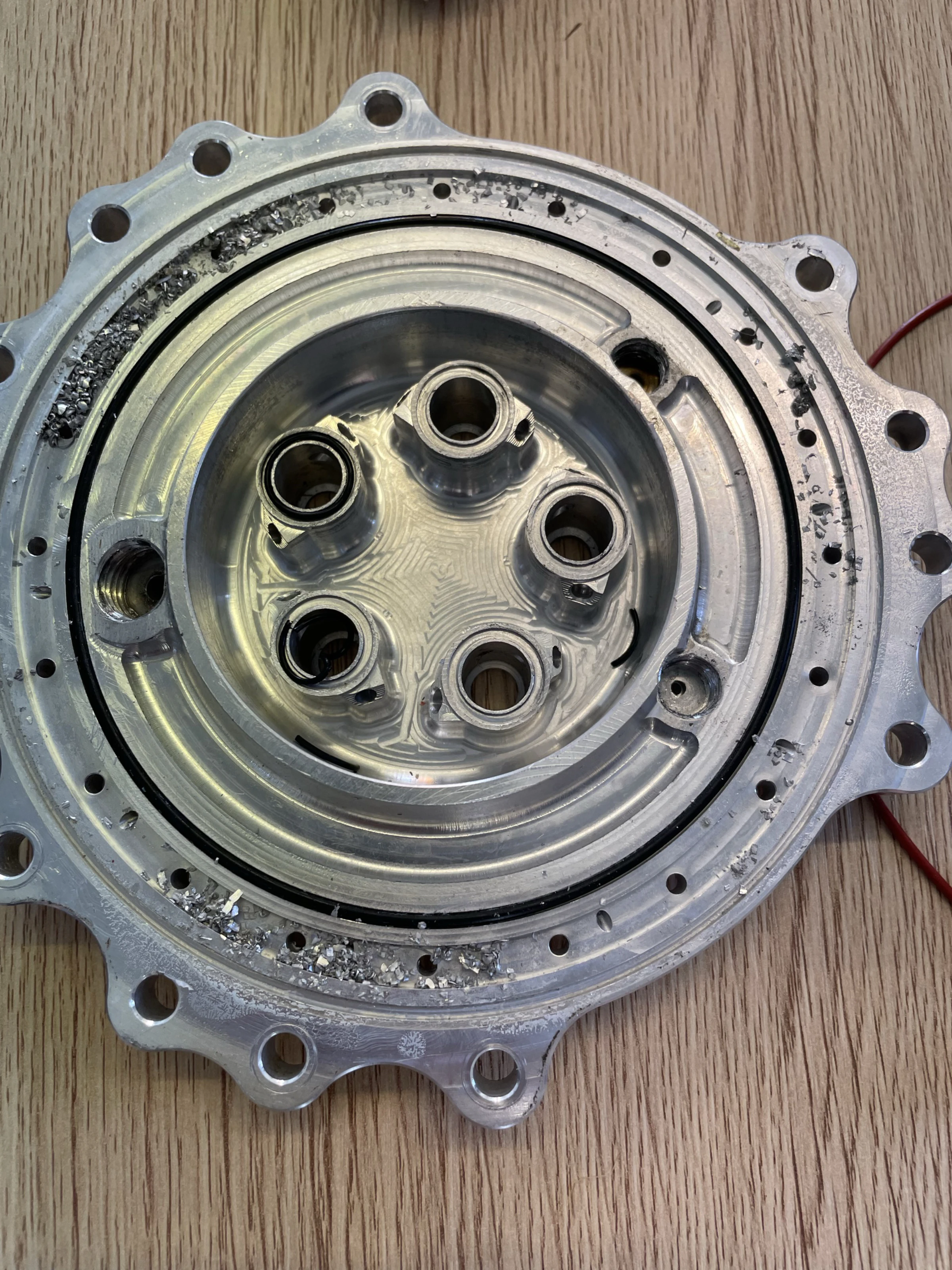 Swirl-element side of the injector with swarf lodged in the annular gallery