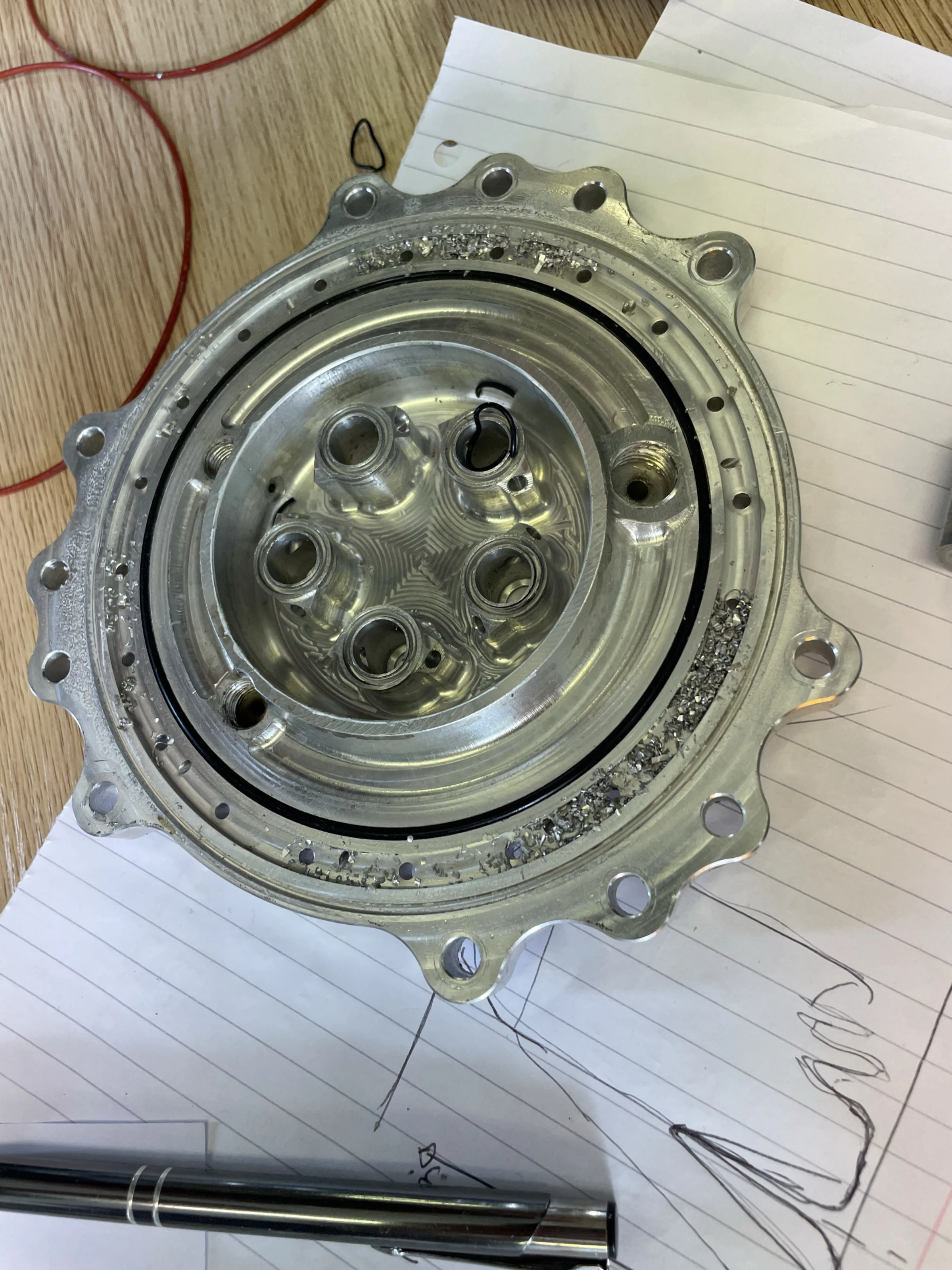 Opened injector with a pile of swarf sitting in the fuel collection manifold