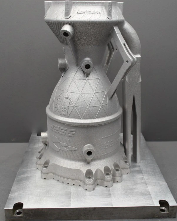 Reverse angle of the as-printed chamber on its build plate with the support strut on the right
