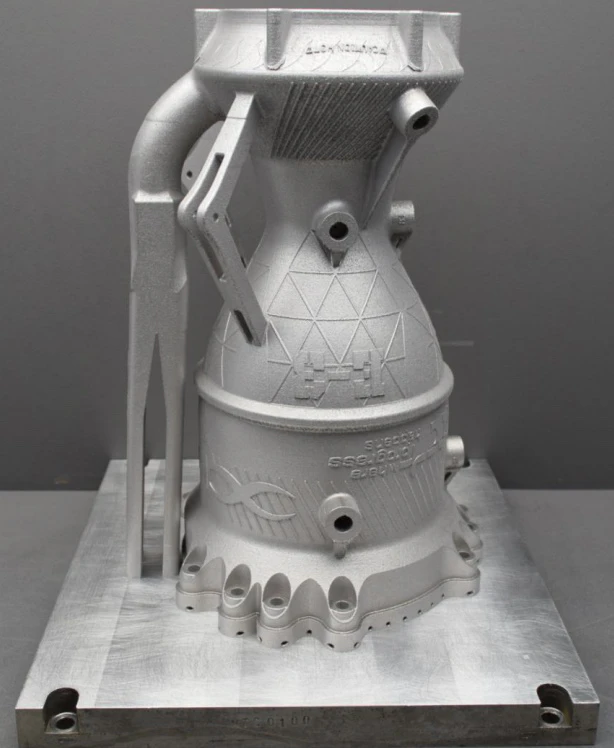 Three-quarter view of the as-printed chamber showing the lattice-textured nozzle section and the scalloped flange