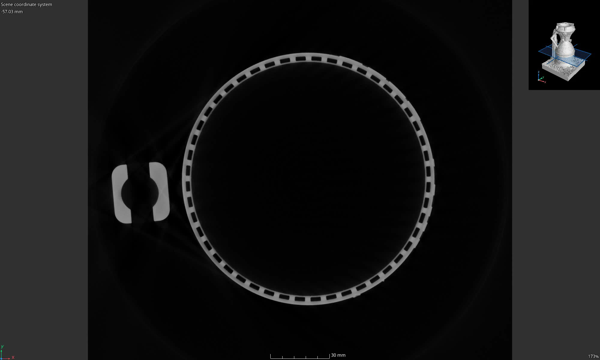 Single X-ray CT horizontal section mid-chamber showing the complete ring of channel voids around the liner
