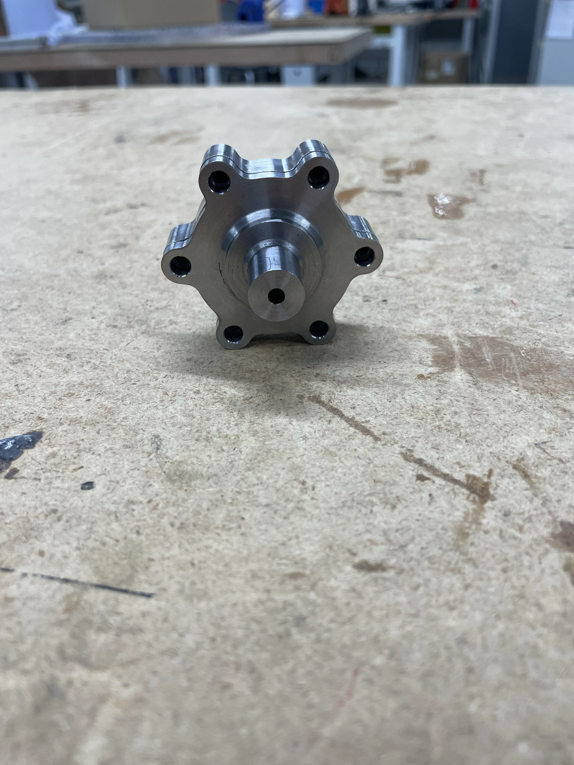 The two igniter halves bolted together into a short hexagonal steel body, fresh from machining.