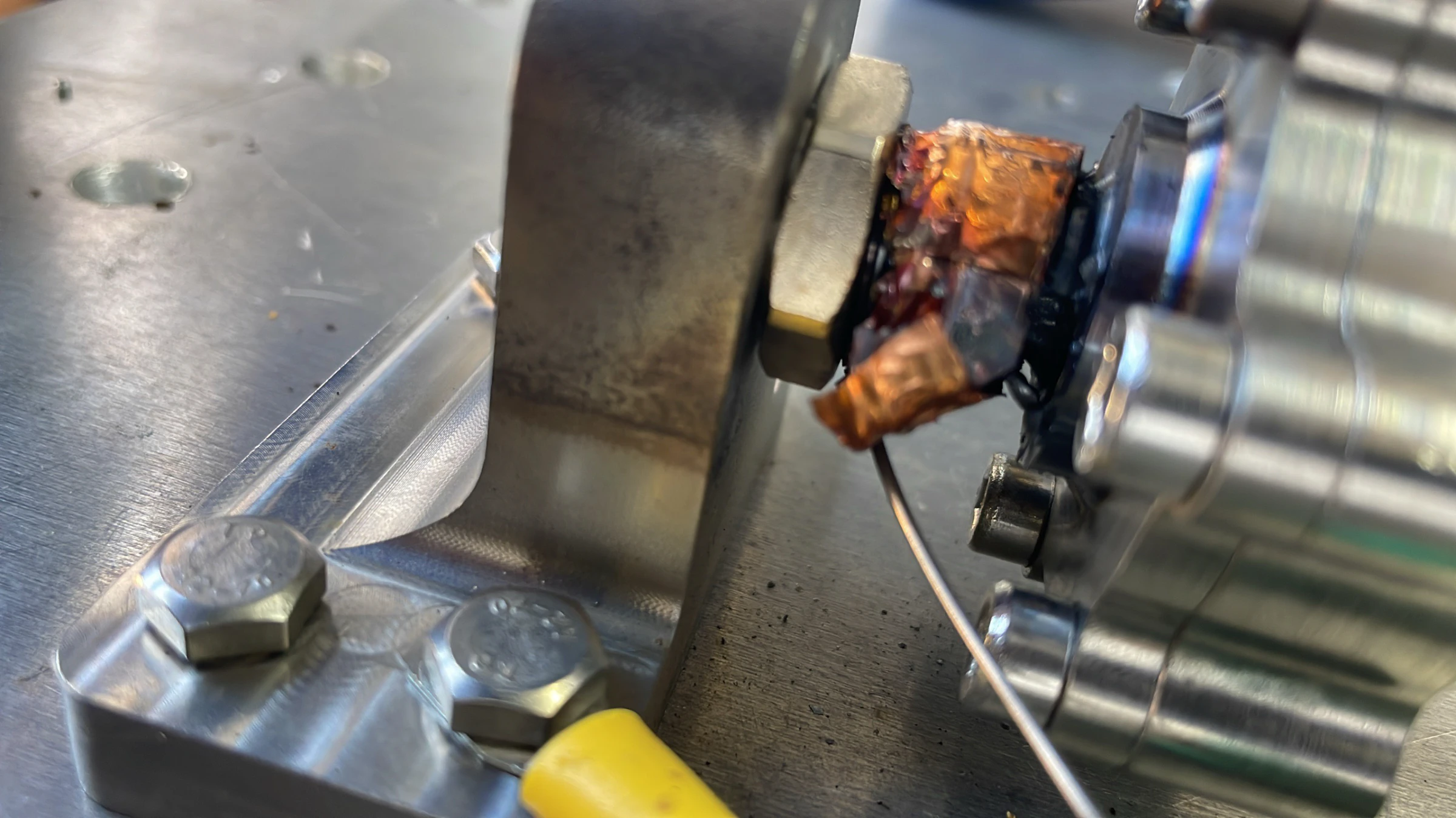 The igniter still mounted after the final burn, a charred and squeezed-out gasket protruding from the joint.
