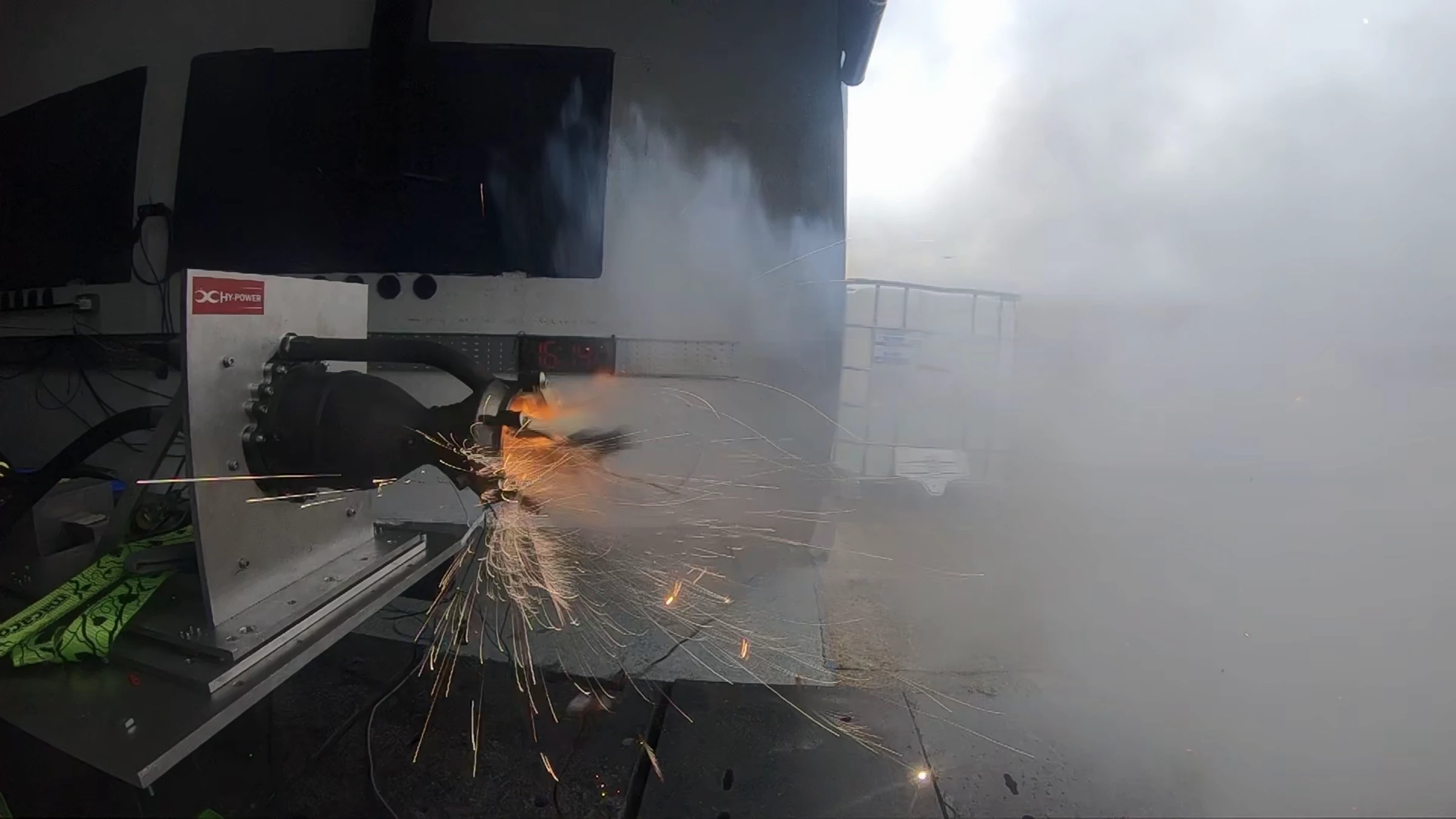 Hotfire 1 ignition: a fountain of sparks off the sparkler at the nozzle exit with vapour still hanging around the engine