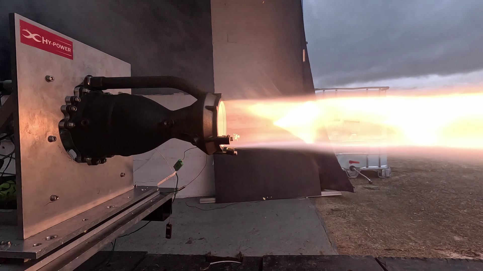 Hotfire 2 mid-burn from the same fixed camera, the bright core of the plume steady