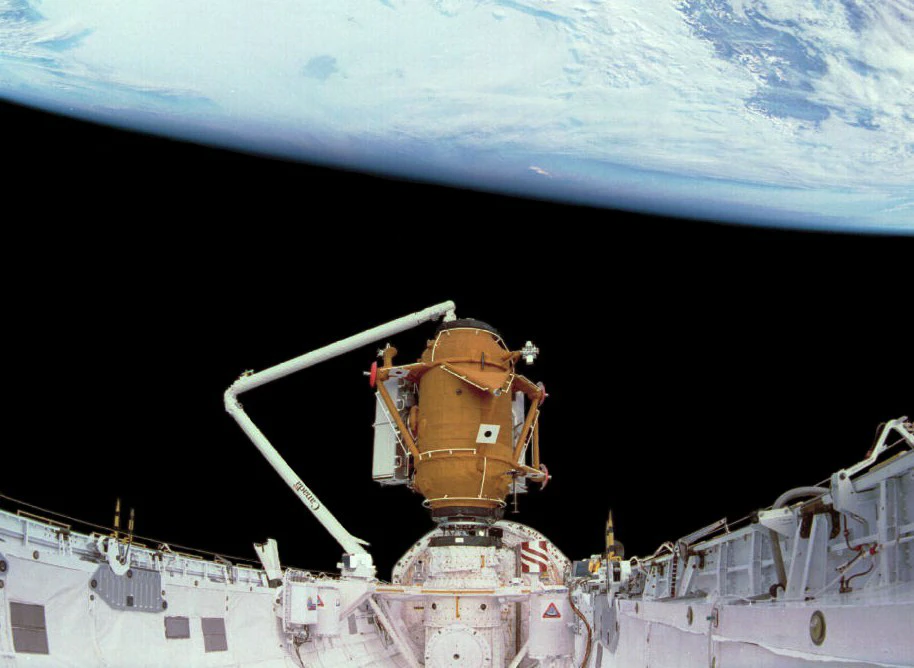 The Docking Module raised on the Orbiter Docking System in Atlantis' open payload bay with the Earth's limb behind